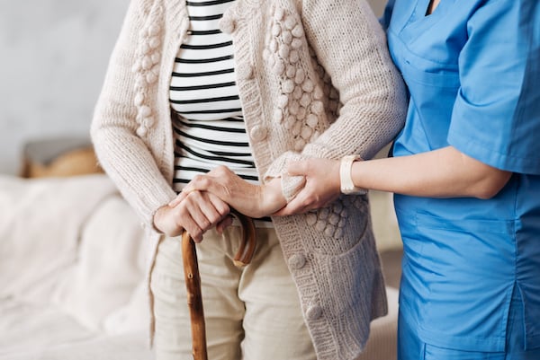 Elderly woman with caretaker