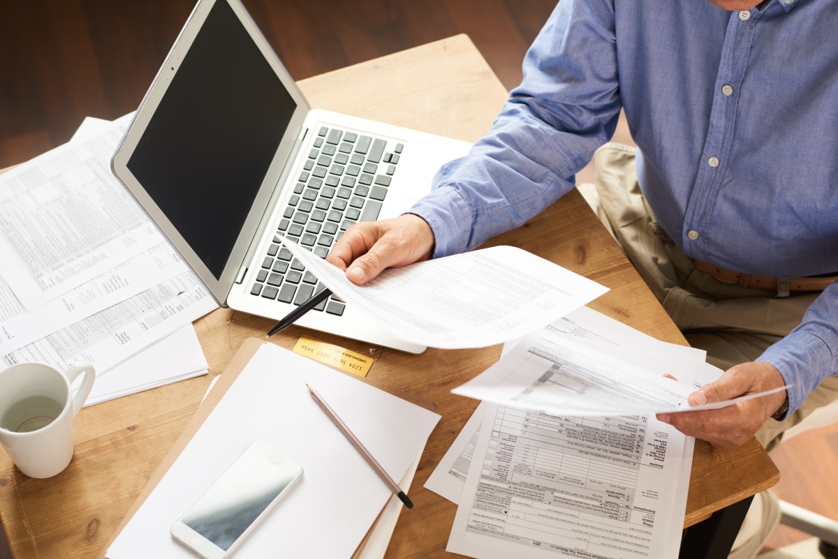 man completing taxes 167657284