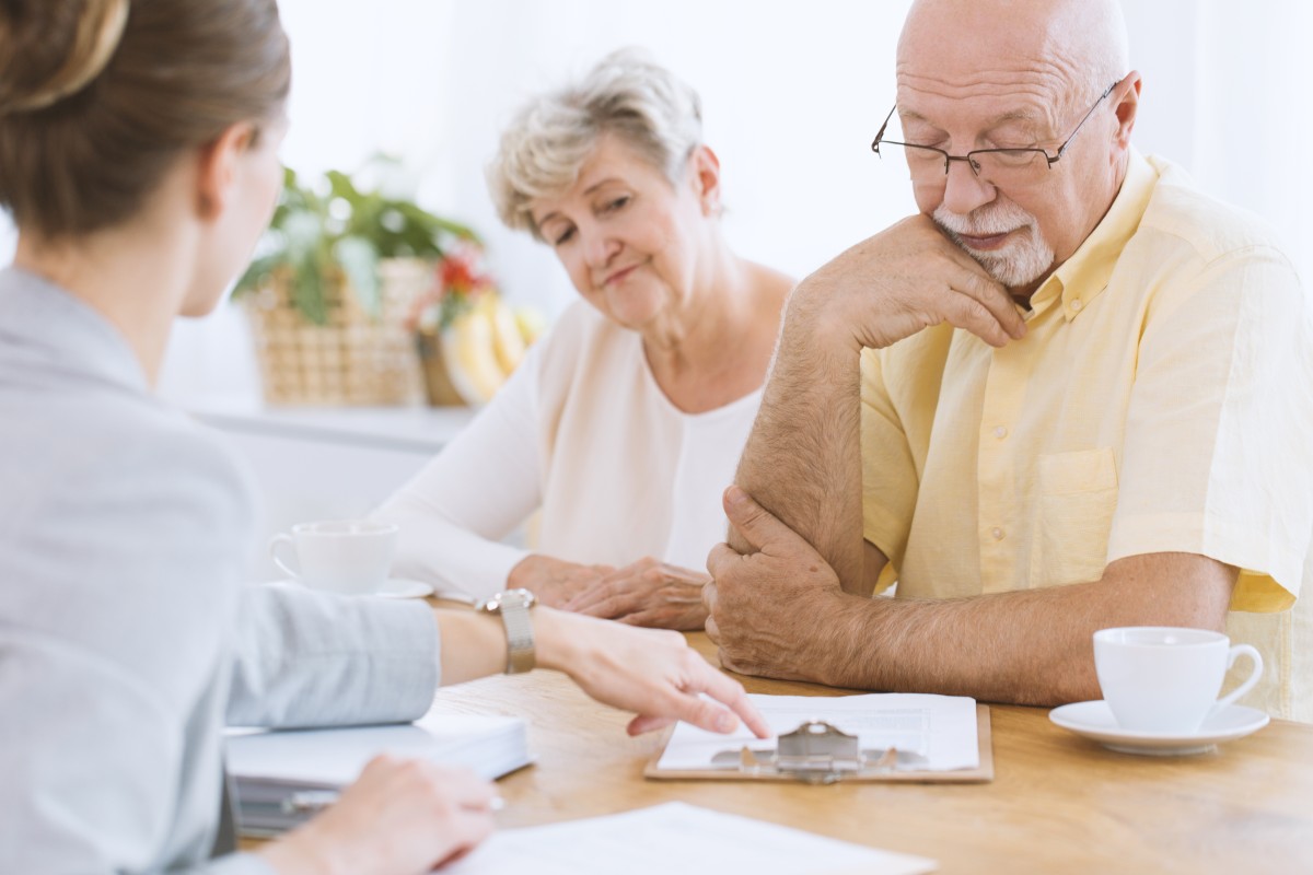 life insurance agent talks with senior couple189632732