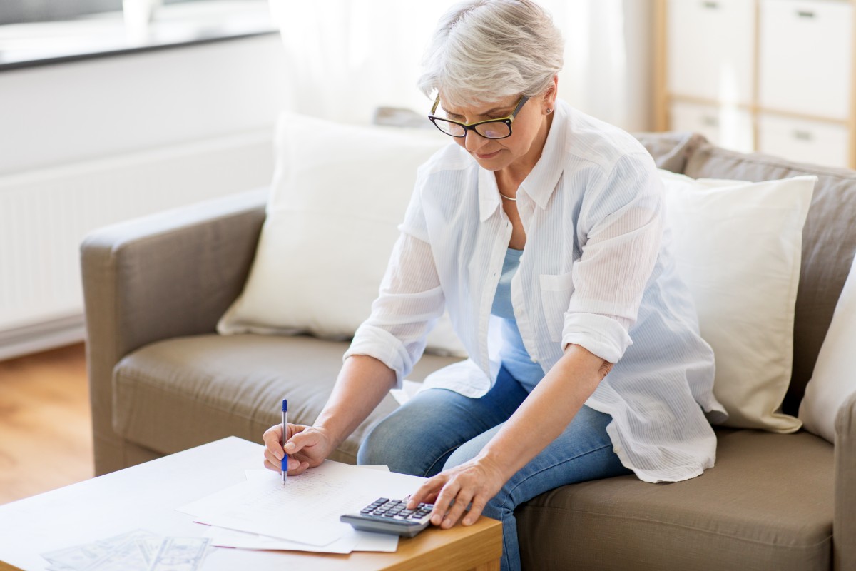 older woman considers annuity documents 212104339
