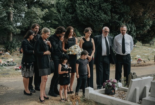 family stands gravesite mourning family member 246070772