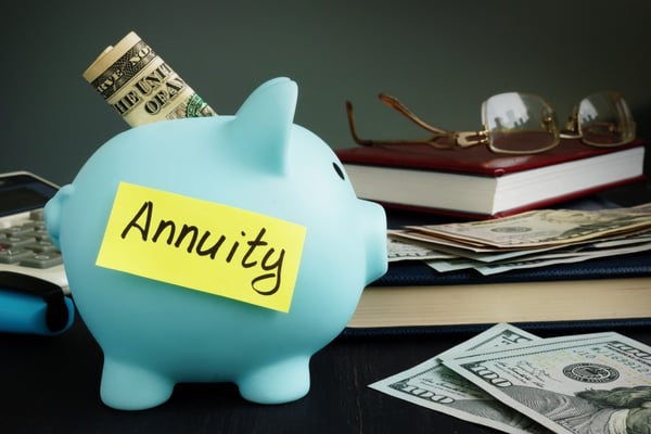piggy bank with dollars and word annuities303472034