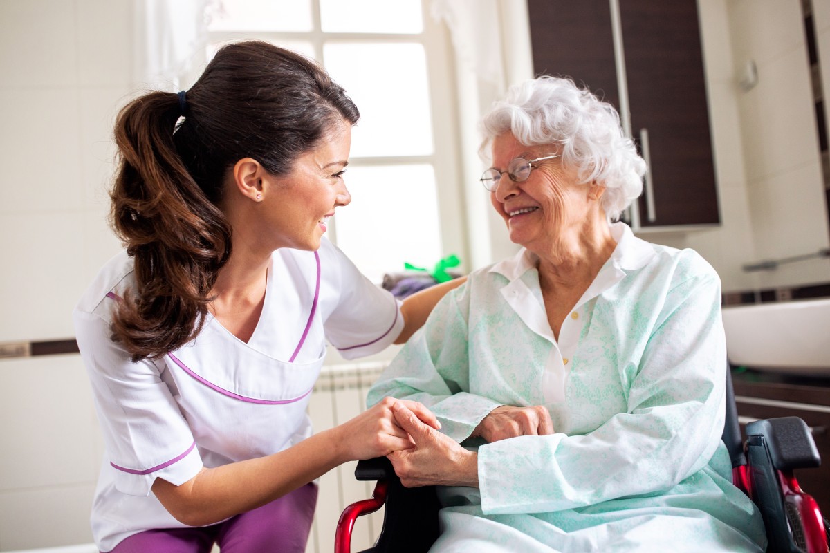 nurse talks to older woman in long  term care405730276