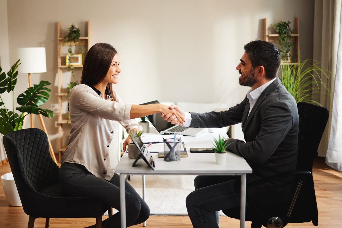 an independent insurance agent shakes hands with another rep