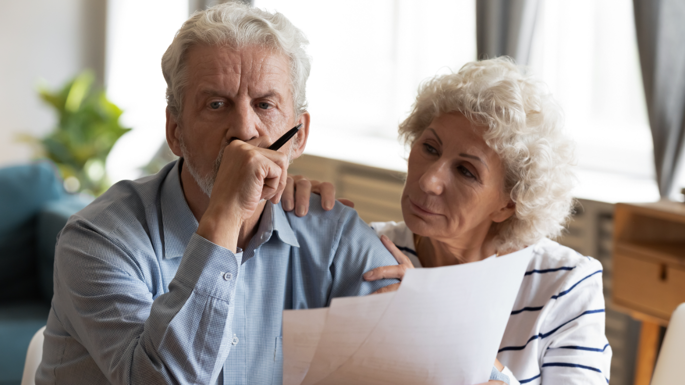 unhappy-older-couple-reading-documents_338278576
