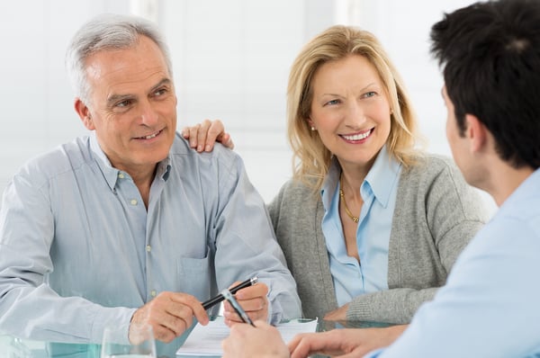 Couple speaking with financial consultant