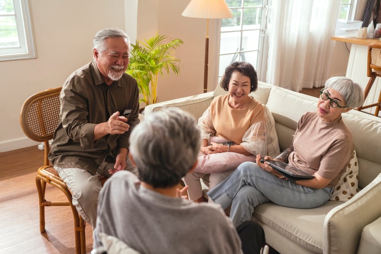 Group of seniors talking with a tablet
