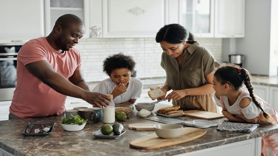family-eating-around-kitchen-counter
