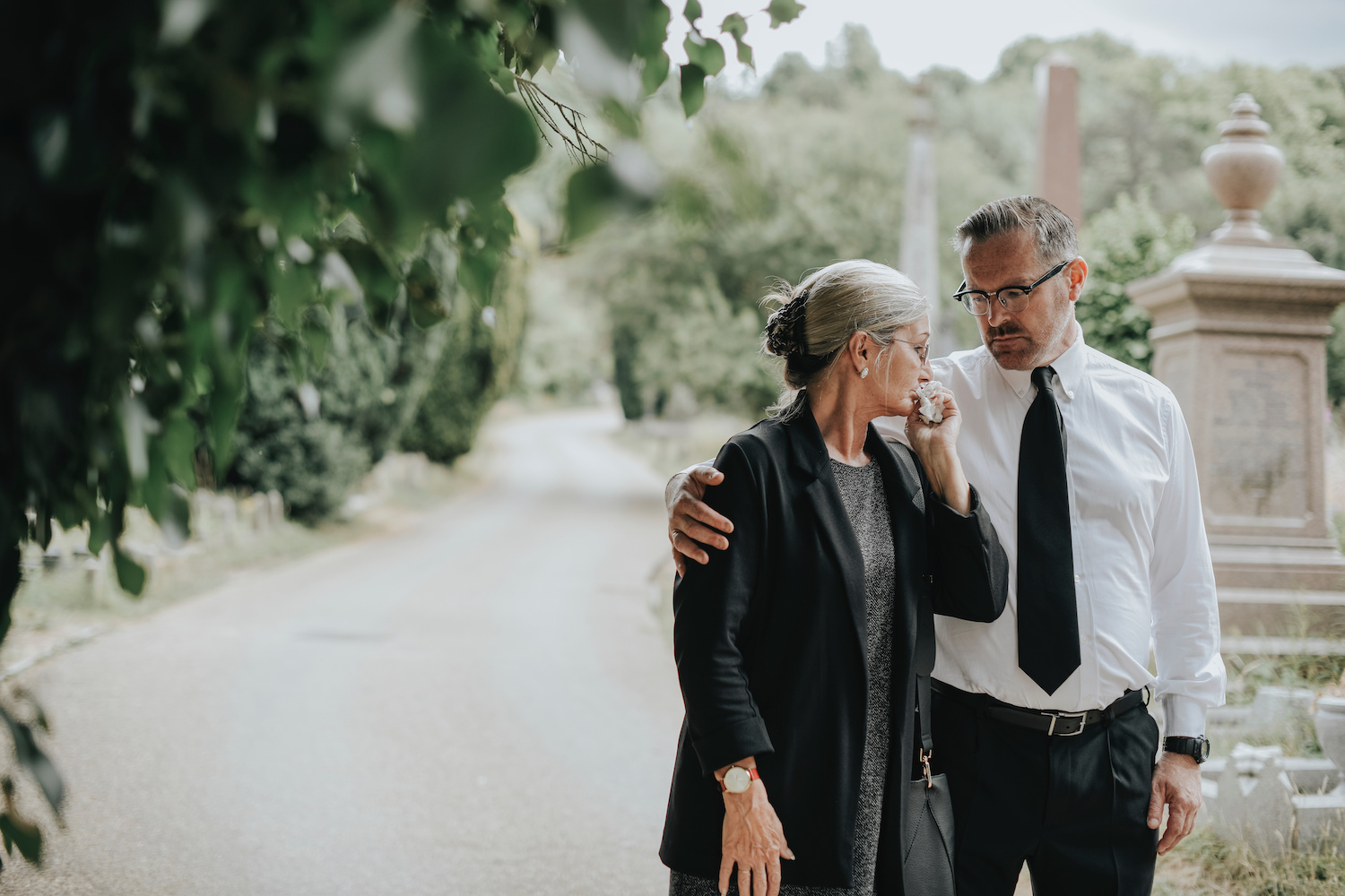 grieving couple discussing funeral plans for their deceased loved one