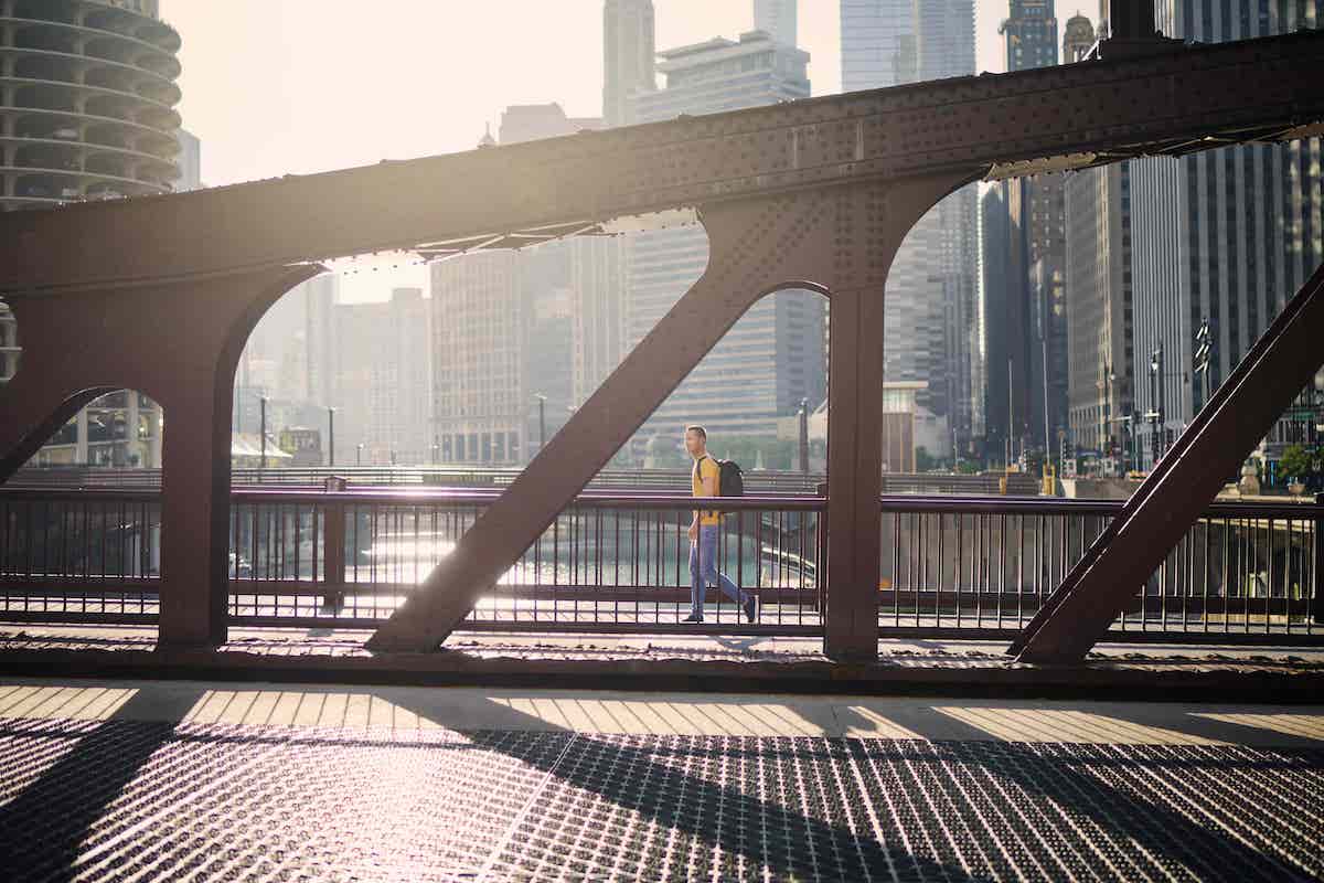 man walking on a bridge